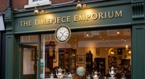 Customised business sign outside a modern UK shop of antiques with clear branding, logo and theme colours.