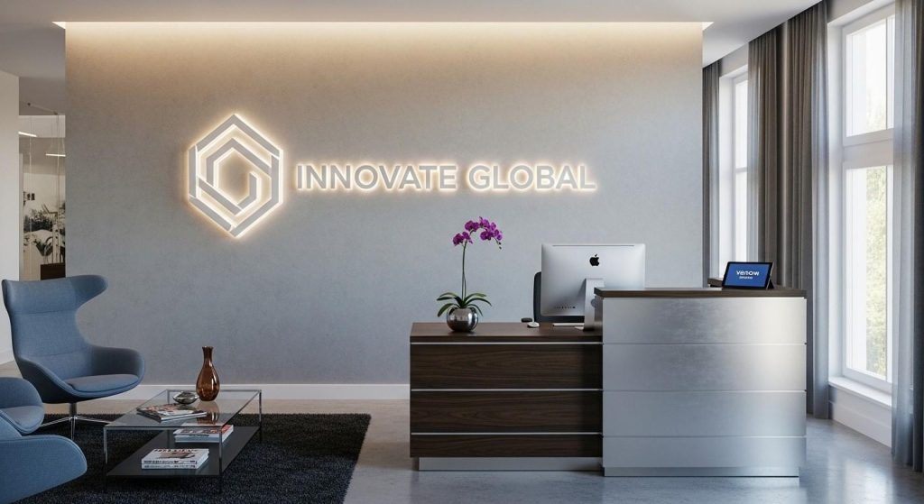 Modern UK office reception with a 3D acrylic reception sign displaying company logo behind the desk, creating a professional first impression.